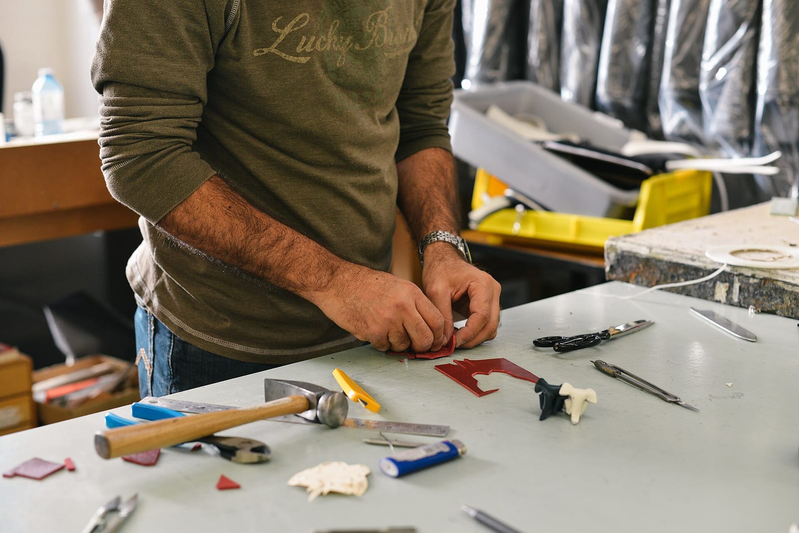 A maker working at a cluttered workbench